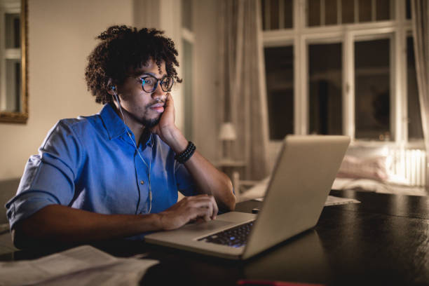 istock Student at home studying while listening to a podcast 1056472976