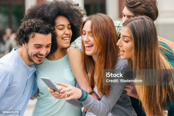 Group Of Friends Are Watching Funny Videos Stock Photo - Download Image Now  - 20-29 Years, Adult, Adults Only - iStock
