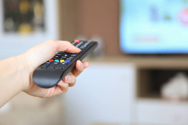 istock Woman looking the tv at home 1056476900