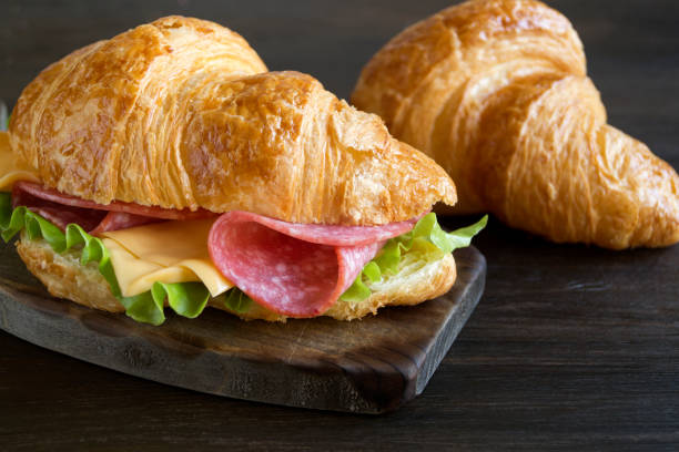 istock Croissant with sausage cheese and herbs. on dark background 1056477864