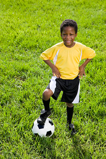 istock Young African American boy standing with soccer ball 105647789