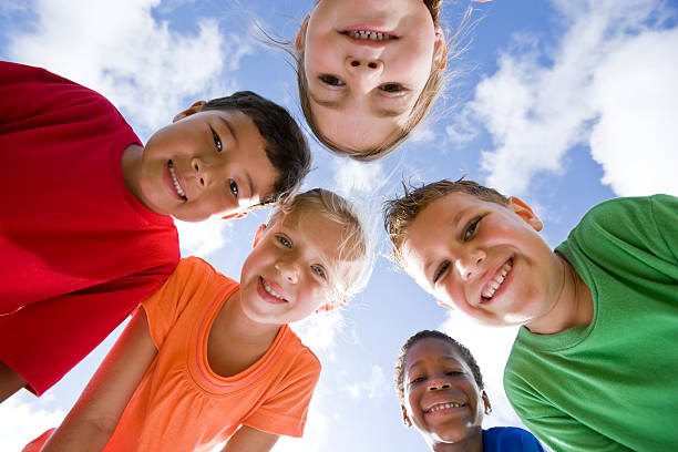 istock Faces of happy diverse young children in huddle 105647804