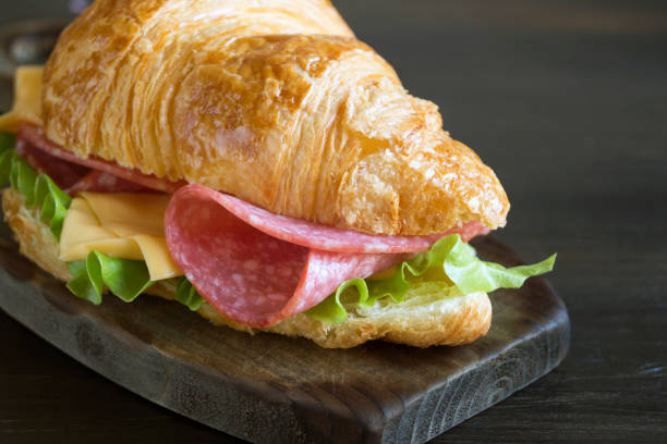 istock Croissant with sausage cheese and herbs. on dark background 1056479542