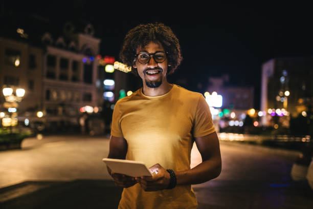 istock Handsome entrepreneur standing on a street holding a digital tablet 1056481230
