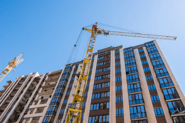 istock Construction of a high-rise building with a crane. Building construction using formwork. Cranes and buildings against the blue sky. 1056483842