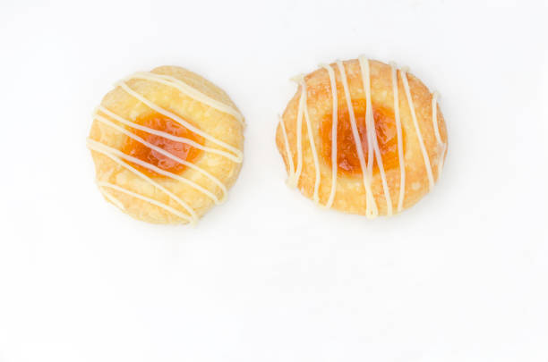Czech Kolache Cookies Homemade cream cheese Kolache cookies filled with apricot and glazed in a plate and served on a festive table for a Christmas holiday menu kolache stock pictures, royalty-free photos & images