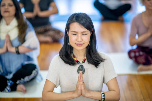 istock Mindful yoga teacher meditates 1056487798