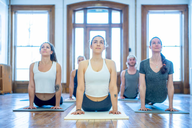 istock Yoga class poses in sun salutation 1056487804