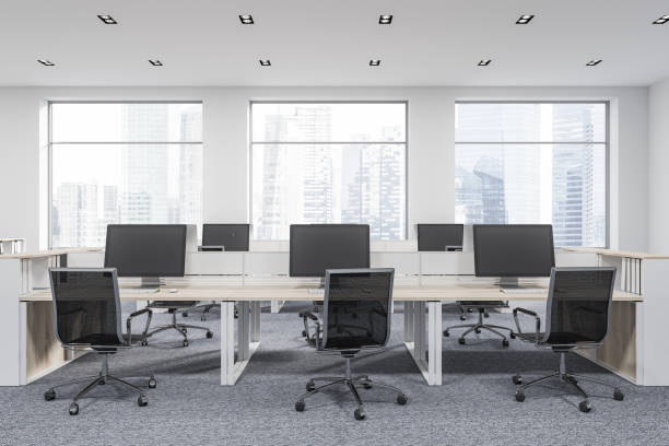 istock Rows of computer tables in startup office, wood 1056488942