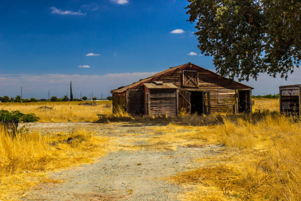 istock Old Weathered Wooden Shed In Field 1056491218