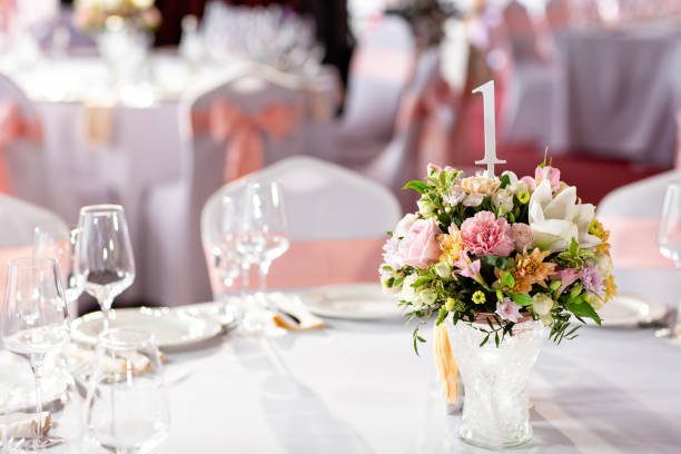 istock Round table at a luxury wedding reception. Beautiful flowers on the table. Serving dishes, glass glasses, waiters work, 1056492754