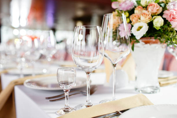 istock Table at a luxury wedding reception. Beautiful flowers on the table. Serving dishes, glass glasses, waiters work, 1056494552