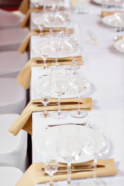 istock Table at a luxury wedding reception. Beautiful flowers on the table. Serving dishes, glass glasses, waiters work, 1056494994