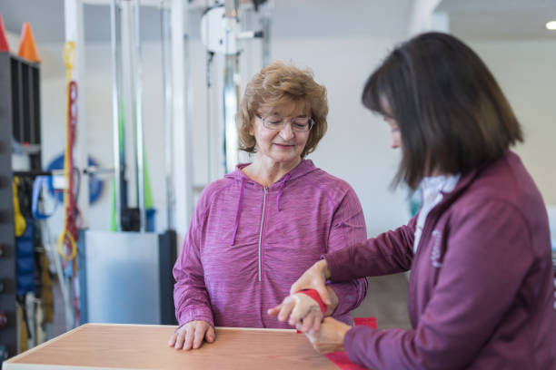 istock Occupational therapist at a clinic working with a senior woman 1056501972