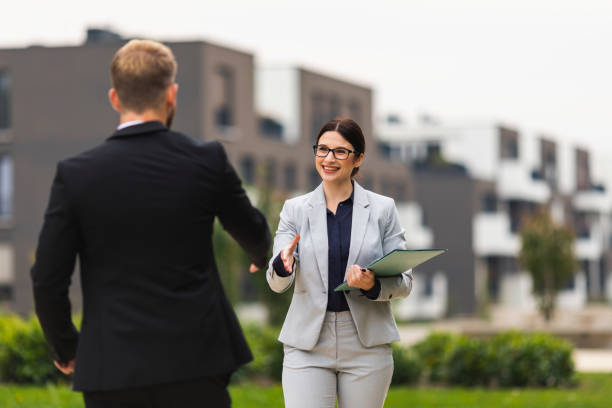 istock Real estate agent greeting her client 1056502520