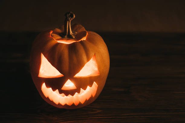 istock Scary jack-o-lantern at halloween celebration night 1056509968