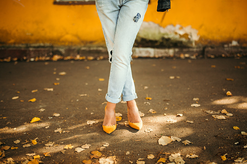 Woman legs in autumn street