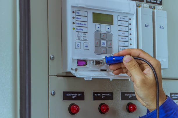 istock Male engineers are connect cable at equipment to laptop for check electrical system working 1056521516
