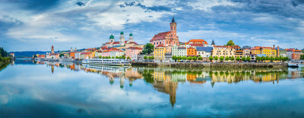 Passau city panorama with Danube river at sunset, Bavaria, Germany Panoramic view of the historic city of Passau reflecting in famous Danube river in beautiful evening light at sunset, Bavaria, Germany passenger craft stock pictures, royalty-free photos & images