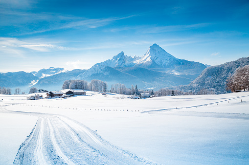 Winter wonderland scenery with trail in the Alps