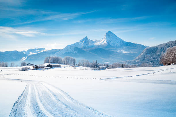 Winter wonderland scenery with trail in the Alps Beautiful winter scenery in the Alps on a cold sunny day with blue sky and clouds bavarian alps photos stock pictures, royalty-free photos & images