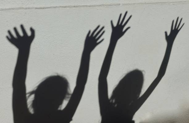 istock Expressive Shadows of girl on wall 1056553972