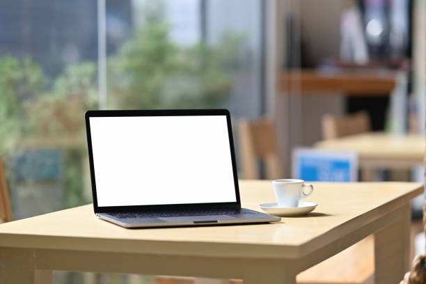 istock Mockup blank screen laptop on table in cafe background. 1056560660