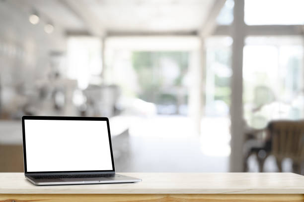 istock Mockup blank screen laptop on table in cafe background. 1056562116