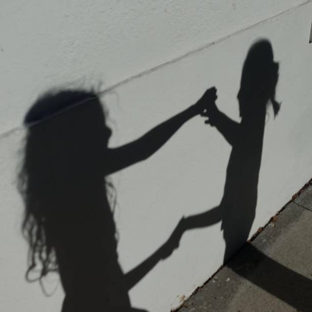 istock Expressive Shadows of girl on wall 1056562186