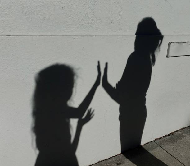 istock Expressive Shadows of girl on wall 1056562188