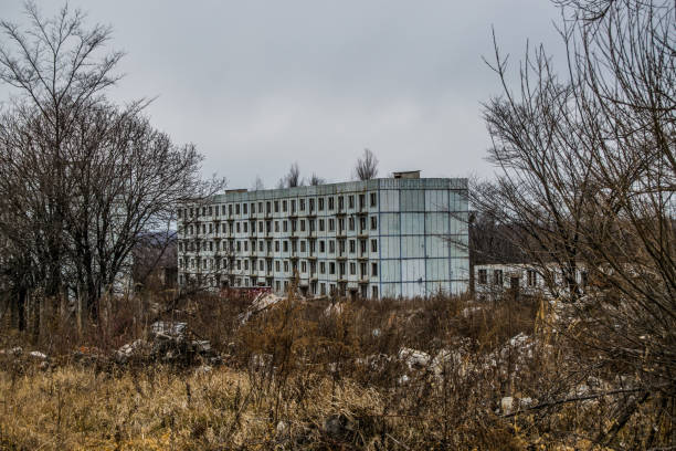 istock Old destroyed an abandoned multi-storey building in a military t 1056564238