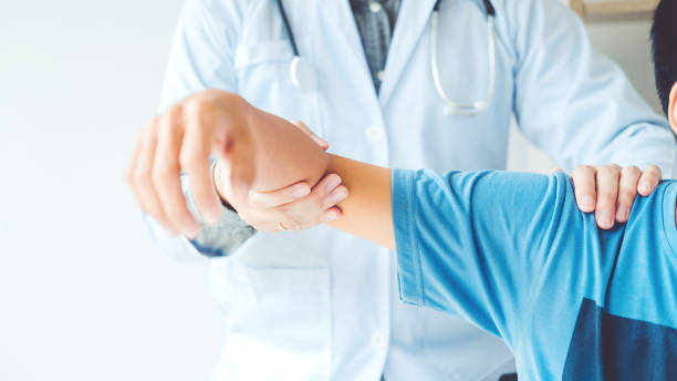istock Doctor consulting with patient Shoulder problems Physical therapy diagnosing concept 1056564346