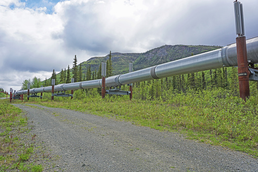 Aerial view of decommissioned pipeline being loaded onto a cargo ship.