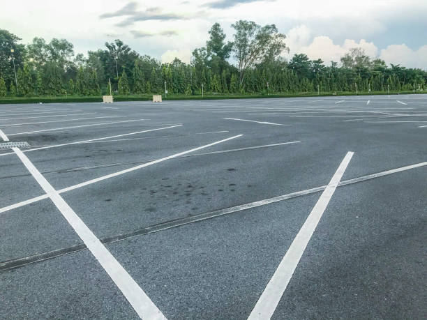 istock empty outdoor car parking lot at evening 1056579892