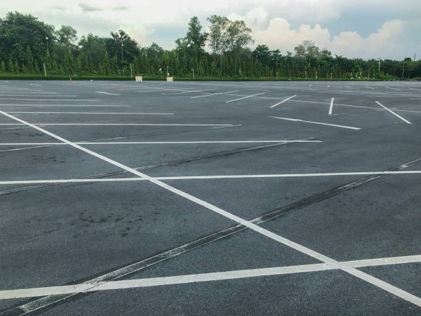 istock empty outdoor car parking lot at evening 1056580910