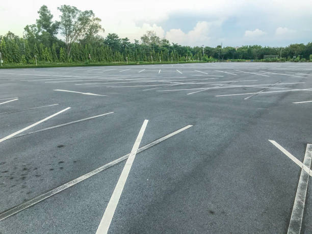 istock empty outdoor car parking lot at evening 1056580914