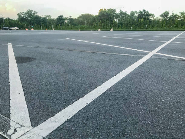 istock empty outdoor car parking lot at evening 1056581970
