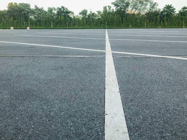 istock empty outdoor car parking lot at evening 1056581974