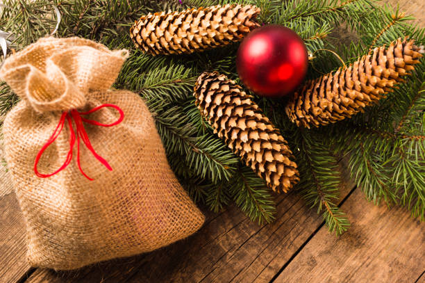 istock New Year eve. Bag with presents, christmas tree with cone 1056588098