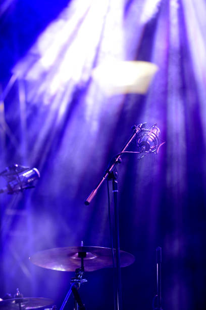 istock microphone on a rock concert, blue light show 1056591184