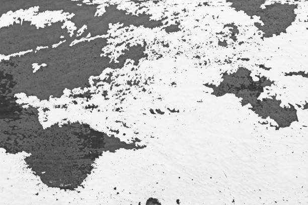 istock Old Flaky Paint Peeling off a Grungy Cracked Wall. Cracks, Peeling Old Paint and Plaster on Background of Old Cement Wall. White and Gray Spots of Paint. An Old Cement Stone Wall as Vintage Cracked 1056591388