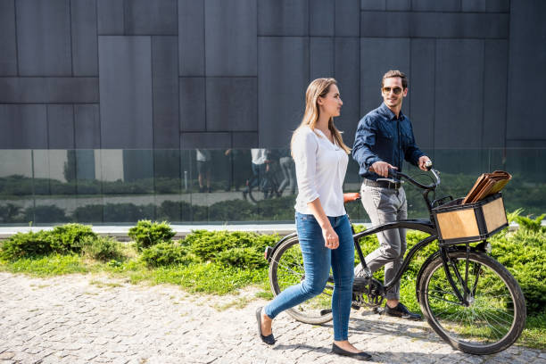 istock Couple with bicycle walking on street 1056591990