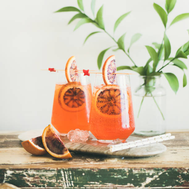 Spritz alcohol cocktail with orange and ice, square crop