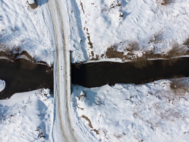 istock village road cross river. overtop view. 1056597382