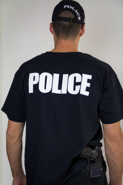 istock Policeman hiding the gun behind his back 1056601042