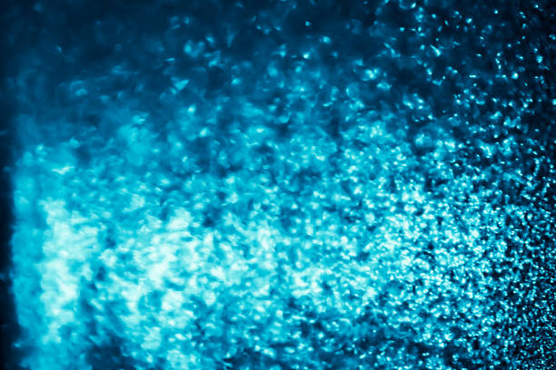 istock Abstract bokeh glitter background. Defocused background. Blurred bright light on black 1056601646
