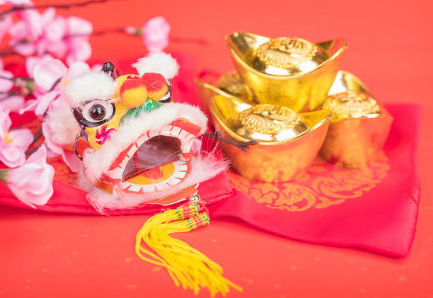 istock chinese traditional dancing lion with ingot 1056613276