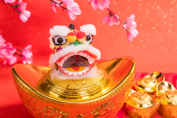 istock chinese traditional dancing lion with ingot 1056613280