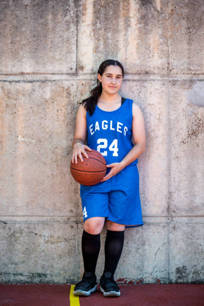 istock Confident girl basketball player against wall 1056617218