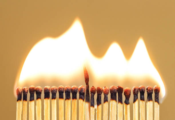 istock Burning match among others on isolated background. Difference and uniqueness concept 1056618614